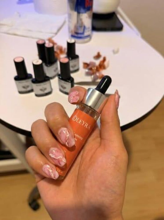 Customer photo holding an Oleyra tanning drops bottle