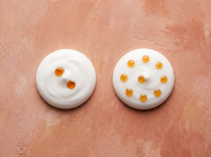 Two dollops of moisturiser, one with two drops in it and one with ten